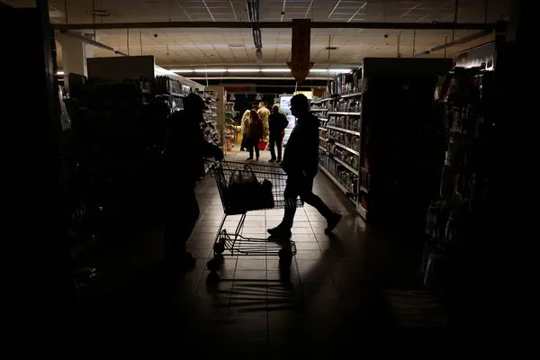 People shopped in a supermarket in Kharkiv, Ukraine, as the city suffered a power outage on Monday.