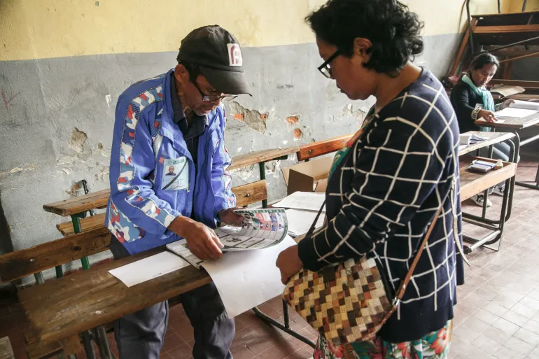 A voter casts his ballot in Antananarivo, Madagascar, in the first round of the presidential vote [Photo Source: Rijasolo/AFP]