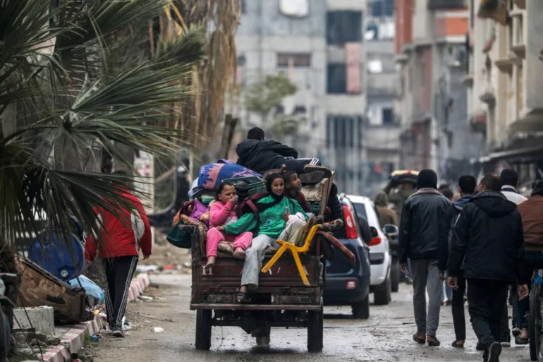 A Palestinian family evacuates following an Israeli military operation in the Bureij refugee camp, Gaza Strip [Photo Source: Mohammed Saber/EPA]