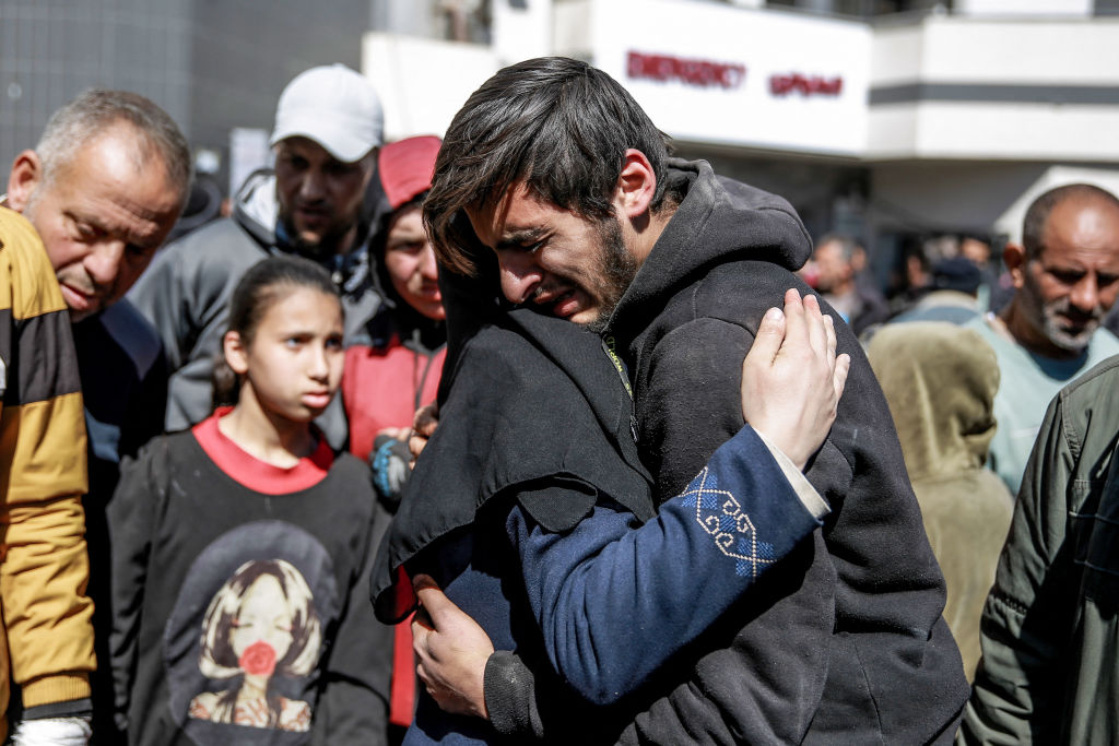 Palestinians mourn following Israel's 'Flour Masscare' where the Israeli military opened fire on Palestinians rushing toward aid trucks in Gaza City [Photo Source: AFP via Getty Images]